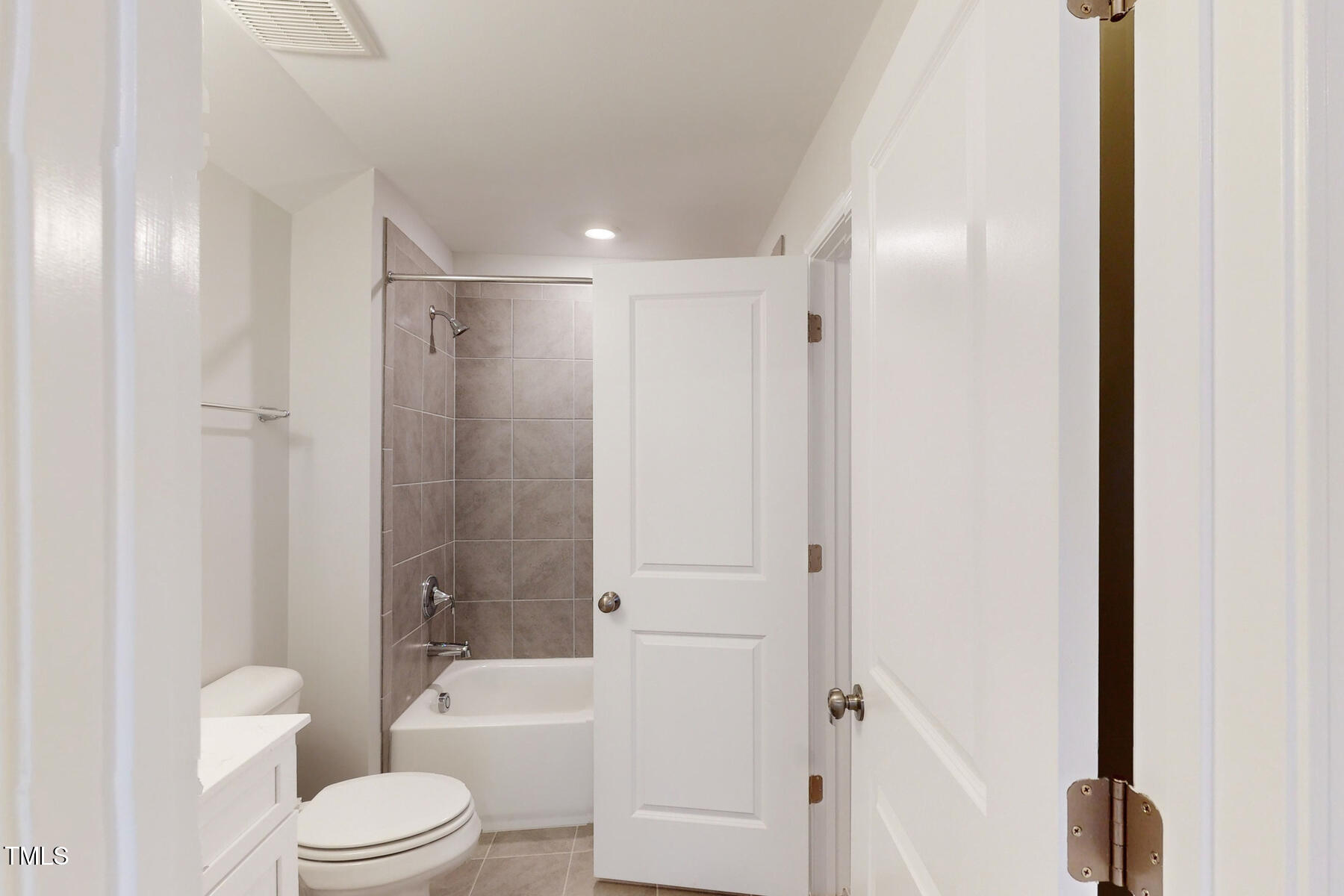 7701 Litcham Drive Raleigh, NC 27615 - Photo 48 of 58 a bathroom with a toilet a sink and a bathtub