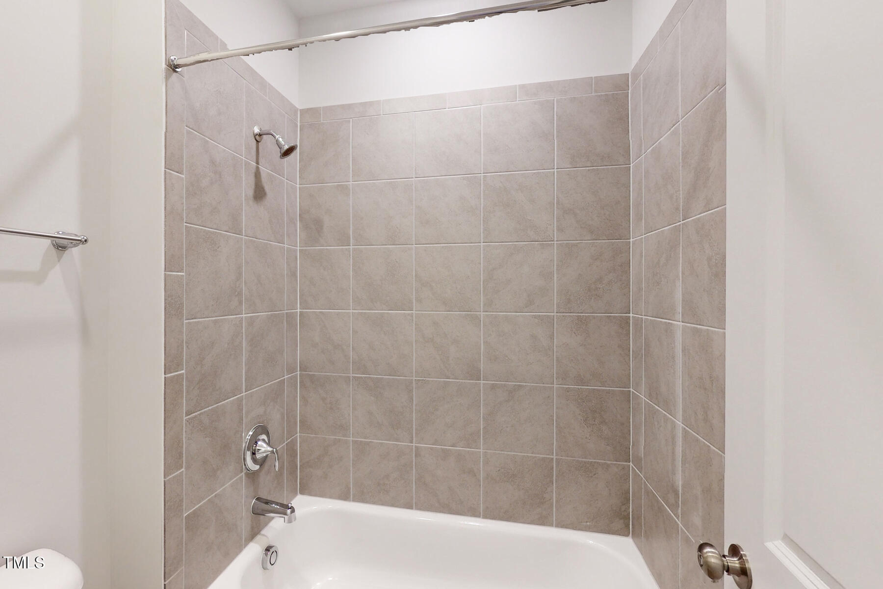 7701 Litcham Drive Raleigh, NC 27615 - Photo 49 of 58 a bathroom with a shower and a toilet