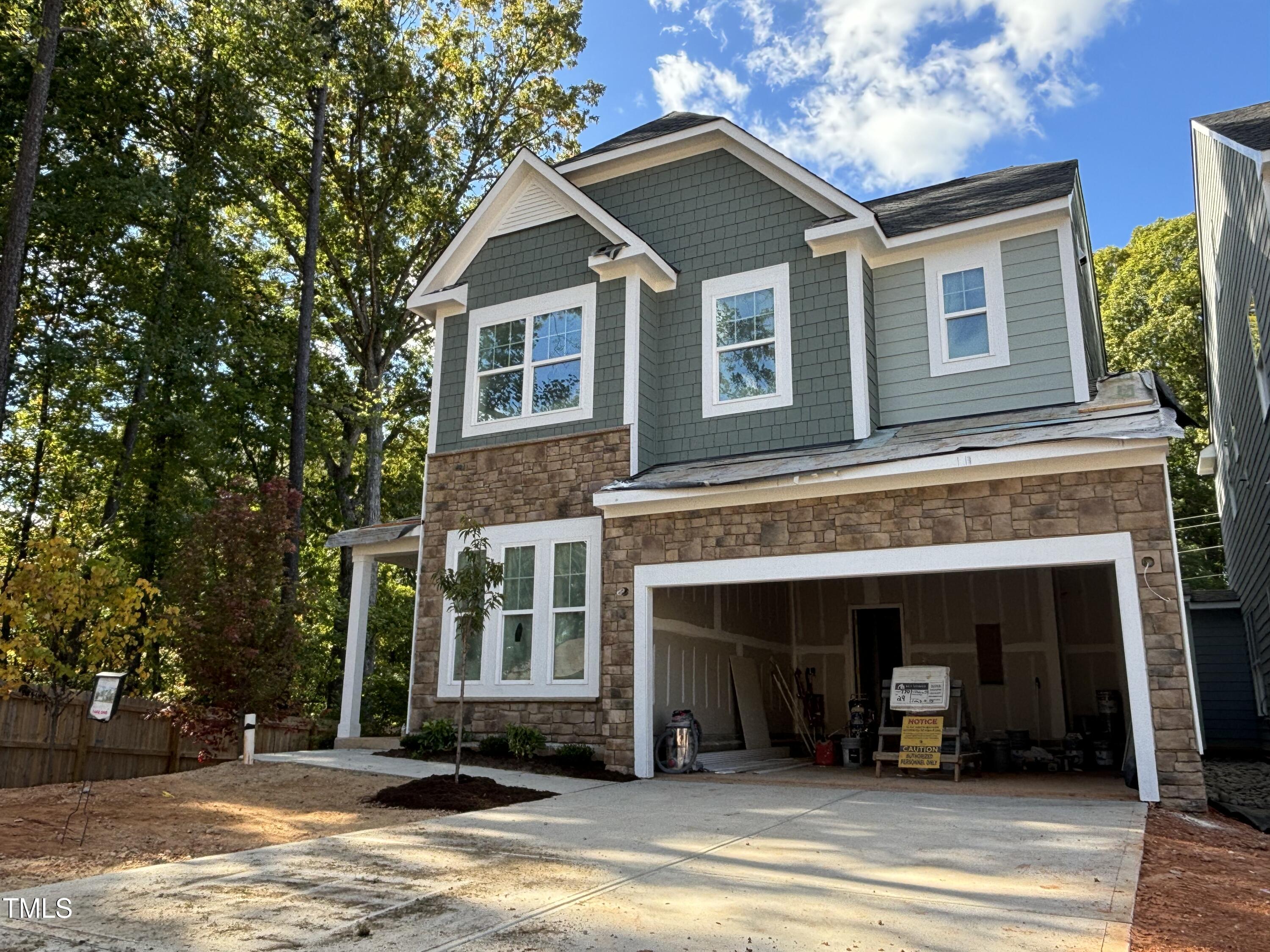 7701 Litcham Drive Raleigh, NC 27615 - Photo 5 of 58 a front view of a house with a yard