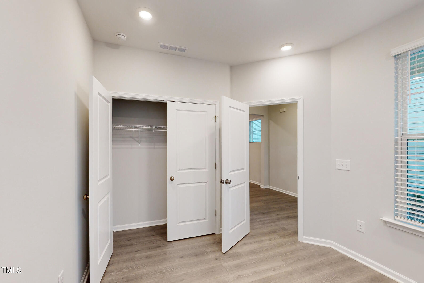 7701 Litcham Drive Raleigh, NC 27615 - Photo 10 of 58 an empty room with closet and windows