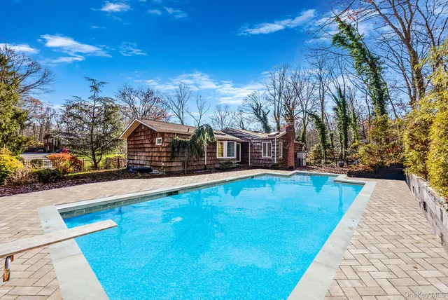 a swimming pool with outdoor seating