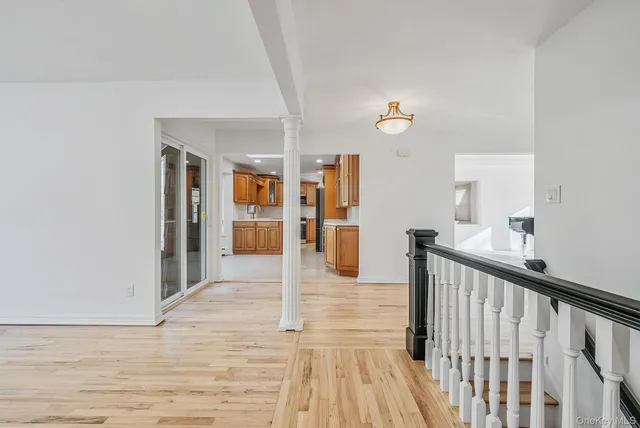 a view of a hallway view with wooden floor and staircase