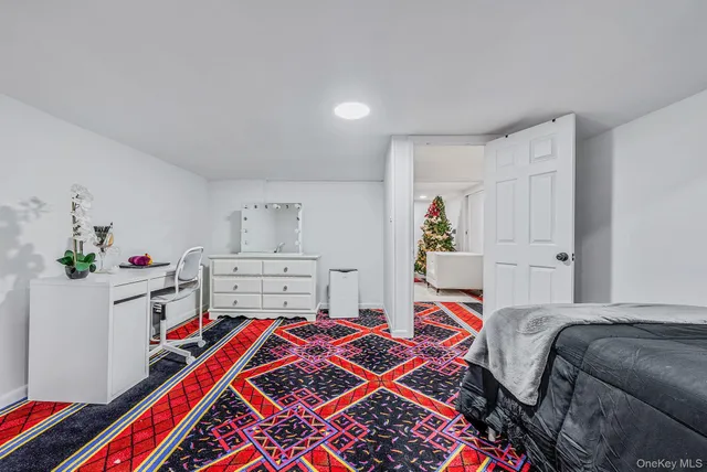 a bedroom with furniture and a baby crib