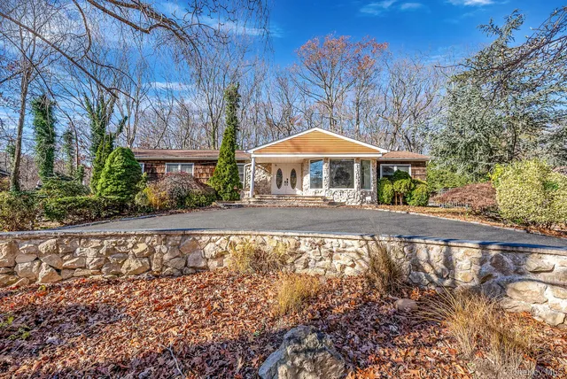 a view of a house with a yard and sitting area