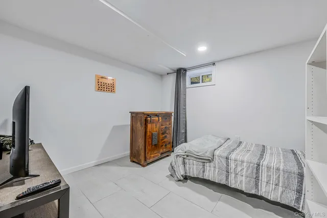 a bedroom with a bed and a television