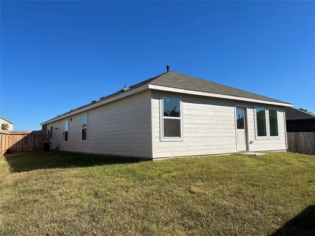 a big house with wooden fence