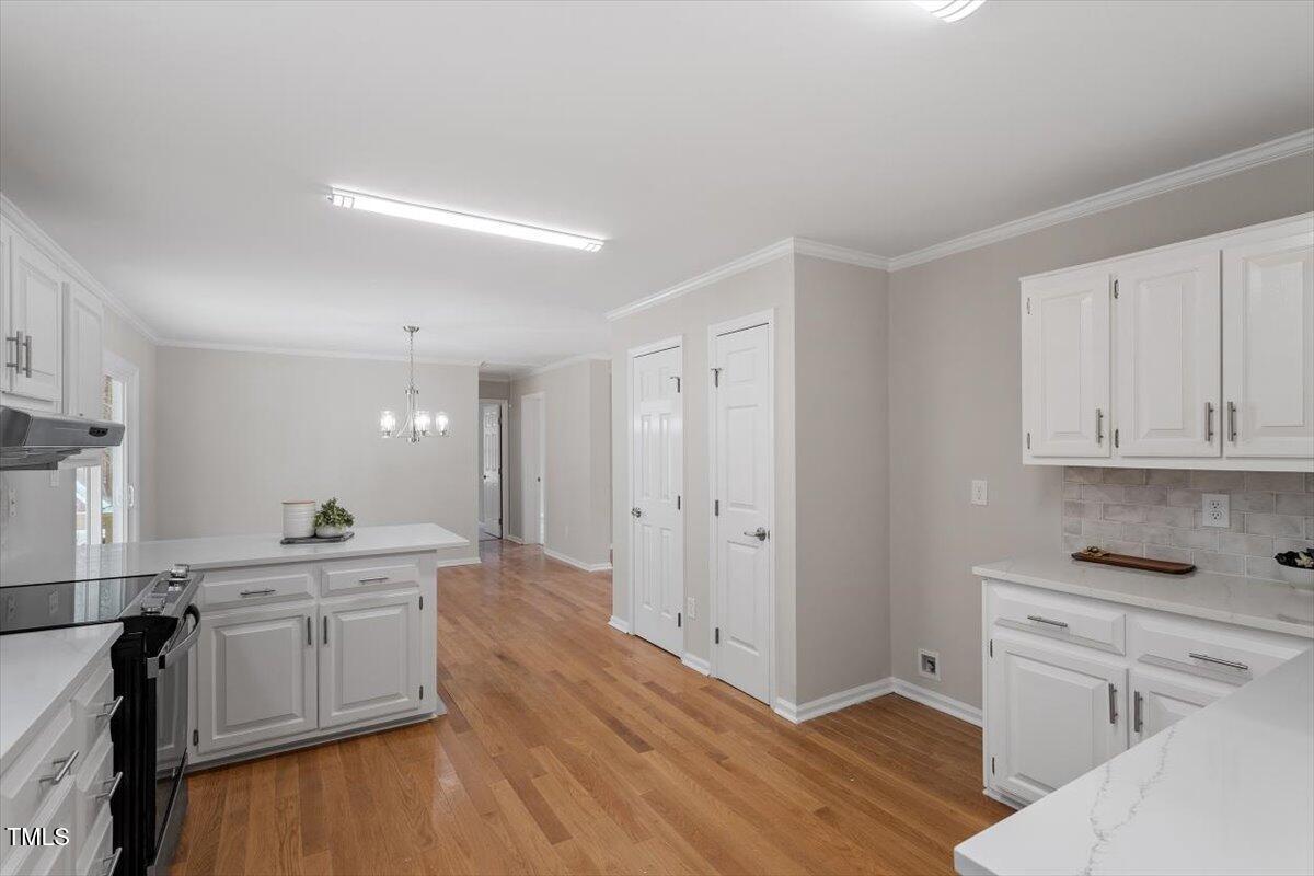 4720 Brigadoon Drive Durham, NC 27705 - Photo 8 of 25 a kitchen with white cabinets and stainless steel appliances