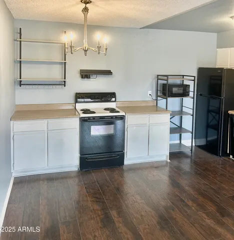 a kitchen with stainless steel appliances granite countertop a stove and a refrigerator