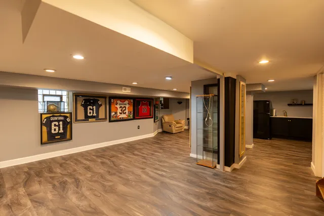 a view of a big room with wooden floor and windows