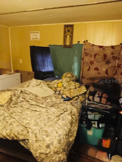 4639 Cr 690 Webster Webster, FL 33597 - Photo 12 of 14 a bed sitting in a bedroom next to a wall