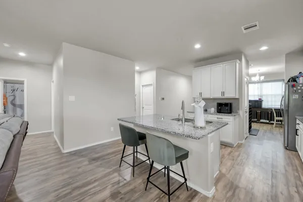 a view of kitchen dining table chairs and wooden floor