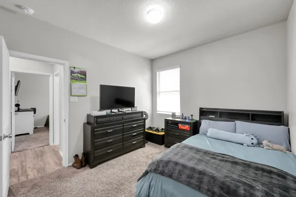 a bedroom with a bed and a flat screen tv