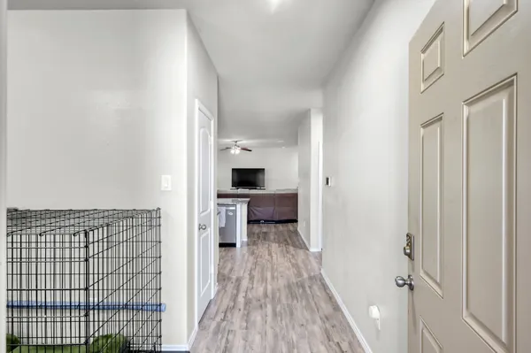 a view of hallway with wooden floor