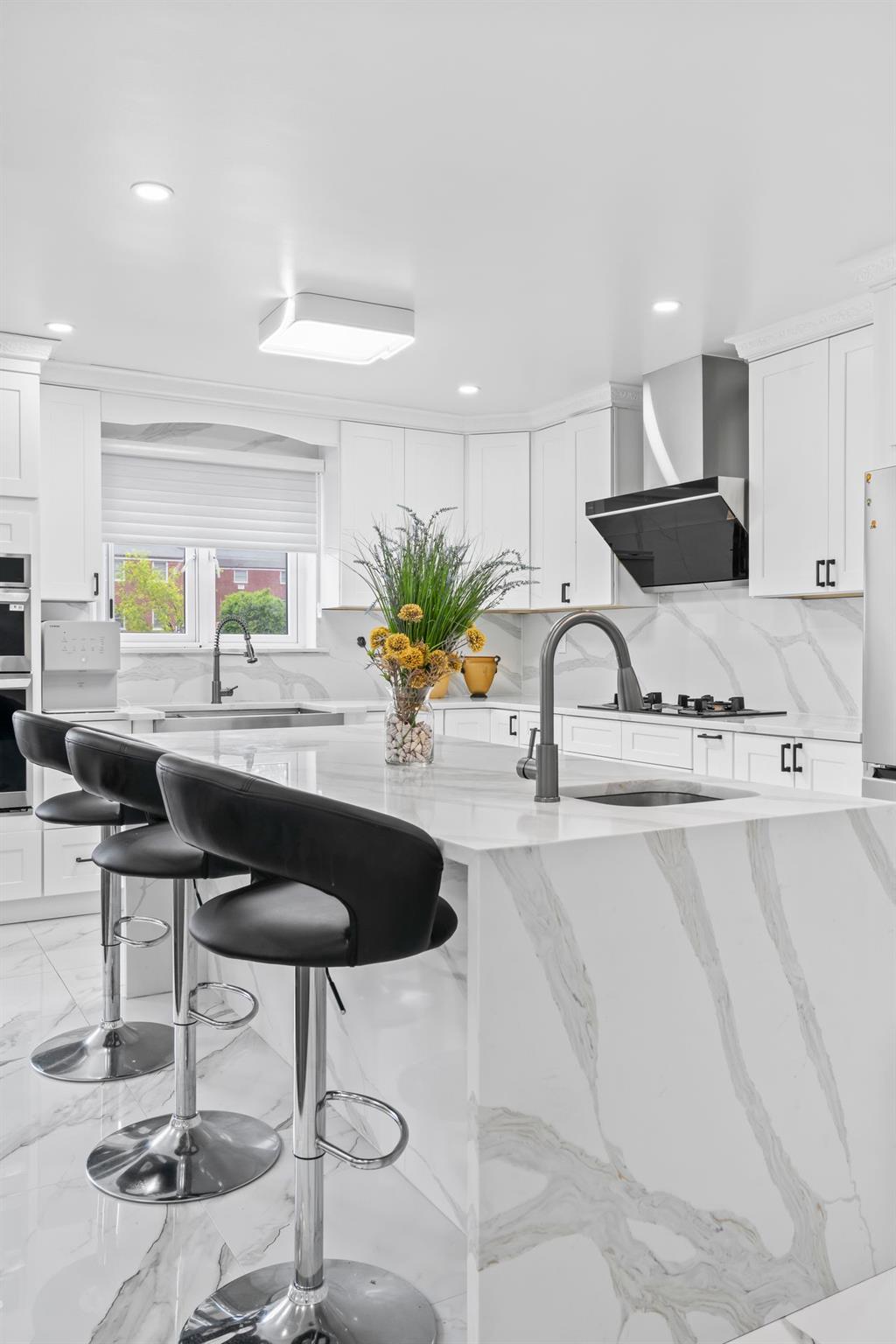 63-41 252nd Street Queens, NY 11362 - Photo 13 of 39 a kitchen with stainless steel appliances kitchen island granite countertop a sink and a white cabinets