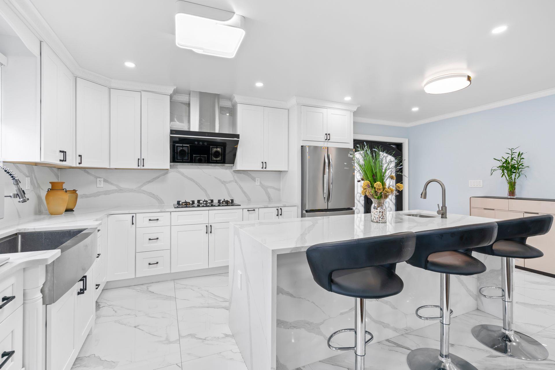 63-41 252nd Street Queens, NY 11362 - Photo 16 of 39 a kitchen with granite countertop a sink white cabinets and stainless steel appliances