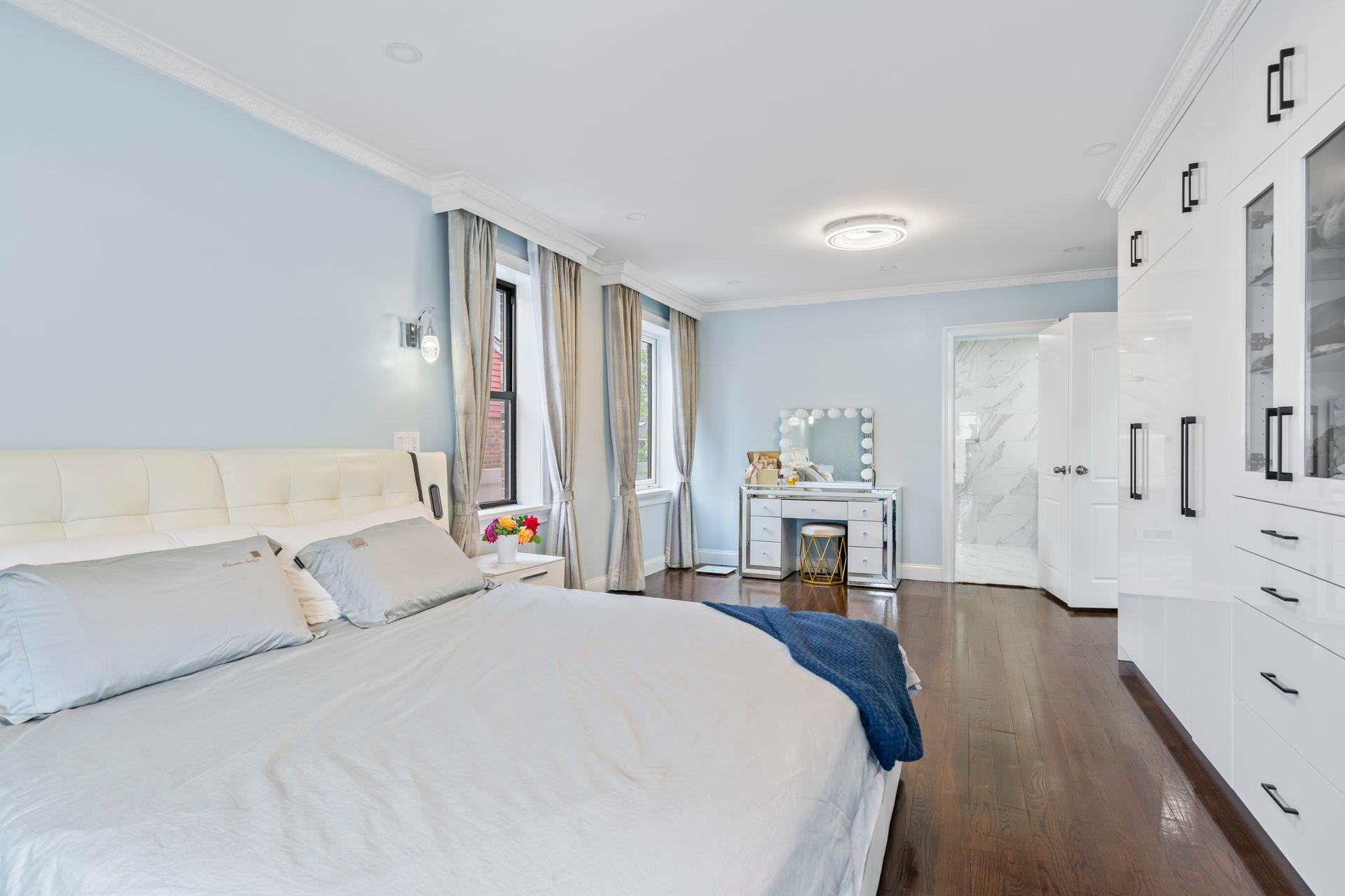 63-41 252nd Street Queens, NY 11362 - Photo 19 of 39 a spacious bedroom with a bed and a fireplace