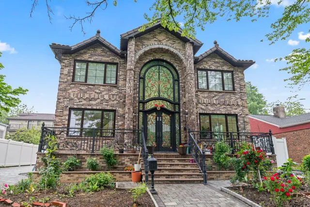 a front view of a house with a garden