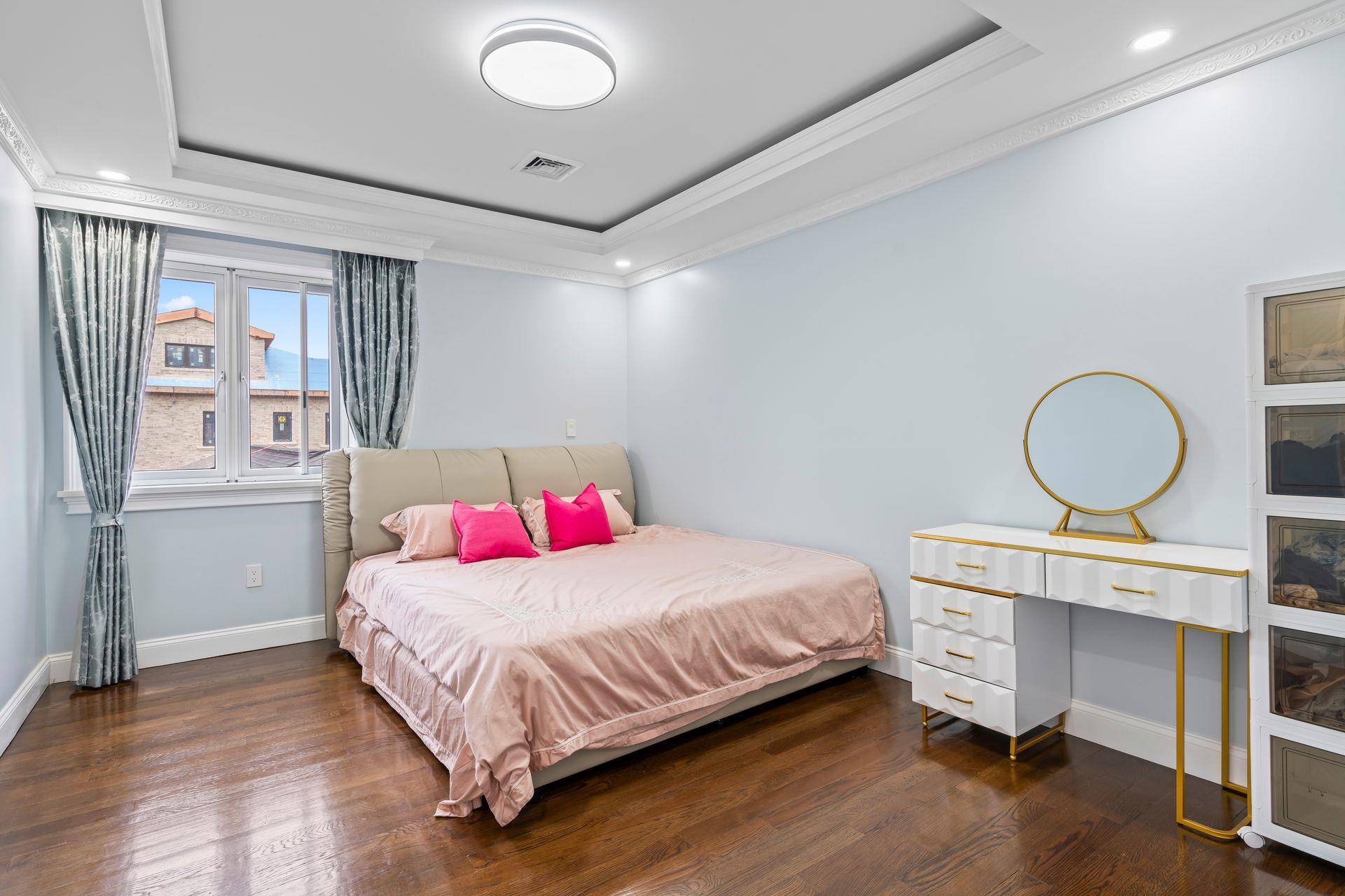 63-41 252nd Street Queens, NY 11362 - Photo 23 of 39 a bedroom with a bed and cabinets