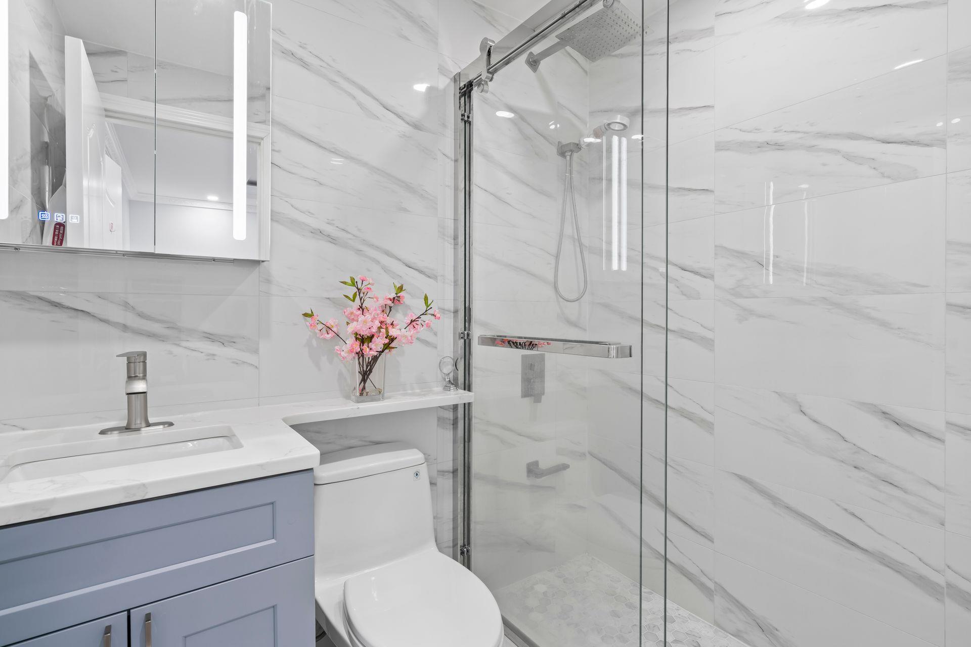 63-41 252nd Street Queens, NY 11362 - Photo 24 of 39 a bathroom with a sink toilet and shower