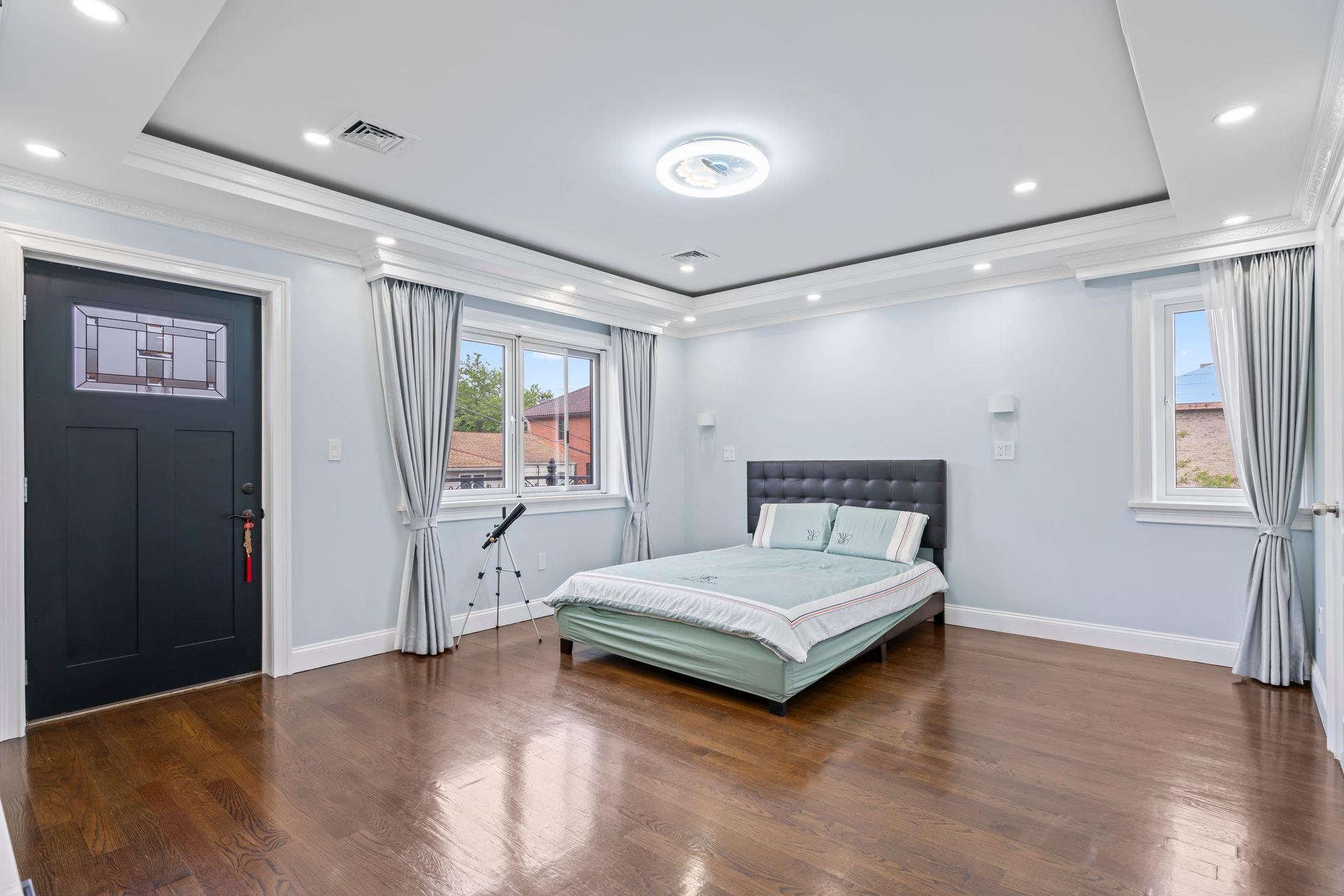 63-41 252nd Street Queens, NY 11362 - Photo 25 of 39 a bedroom with a bed and a window