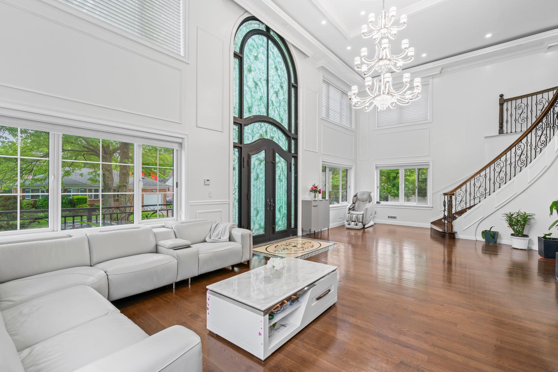63-41 252nd Street Queens, NY 11362 - Photo 5 of 39 a living room with furniture chandelier and a large window