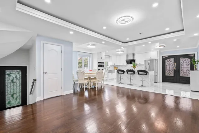 a view of a dining room with furniture and wooden floor
