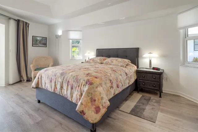 a bedroom with a bed and a night stand