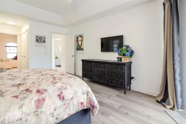 a bedroom with a bed and a television