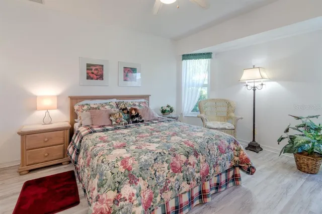 a bedroom with a bed and a lamp on dresser