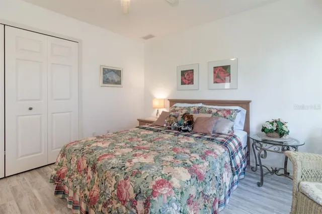 a bedroom with bed and wooden floor