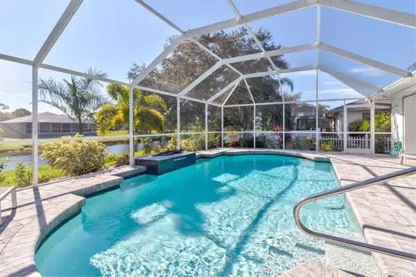 a view of a swimming pool with a patio and a yard