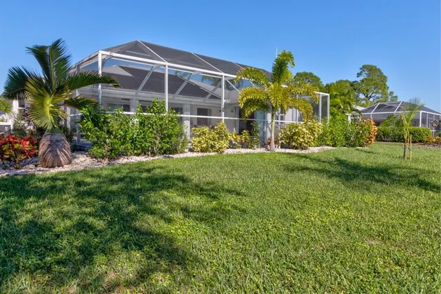 a front view of multi story residential apartment building with a yard