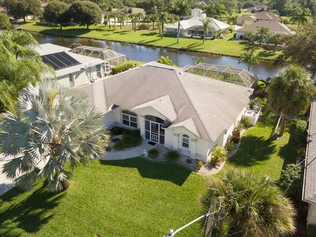 an aerial view of a house with a lake view