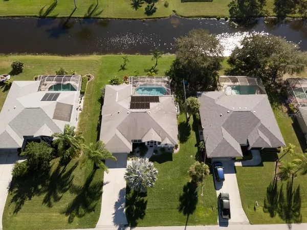 an aerial view of a house with a yard