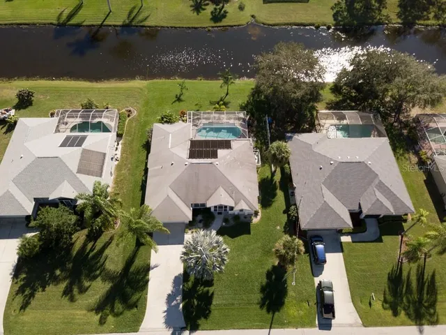 an aerial view of a house with a yard