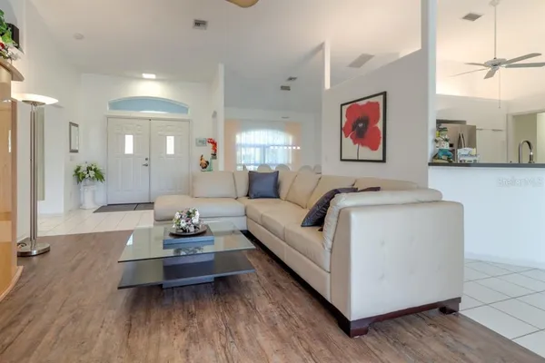 a living room with furniture and a wooden floor