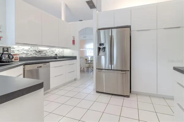 a kitchen with stainless steel appliances a refrigerator sink and cabinets
