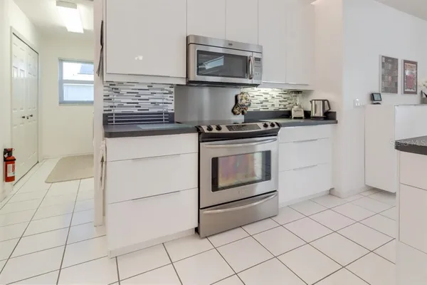 a kitchen with stainless steel appliances granite countertop a stove a microwave and a refrigerator