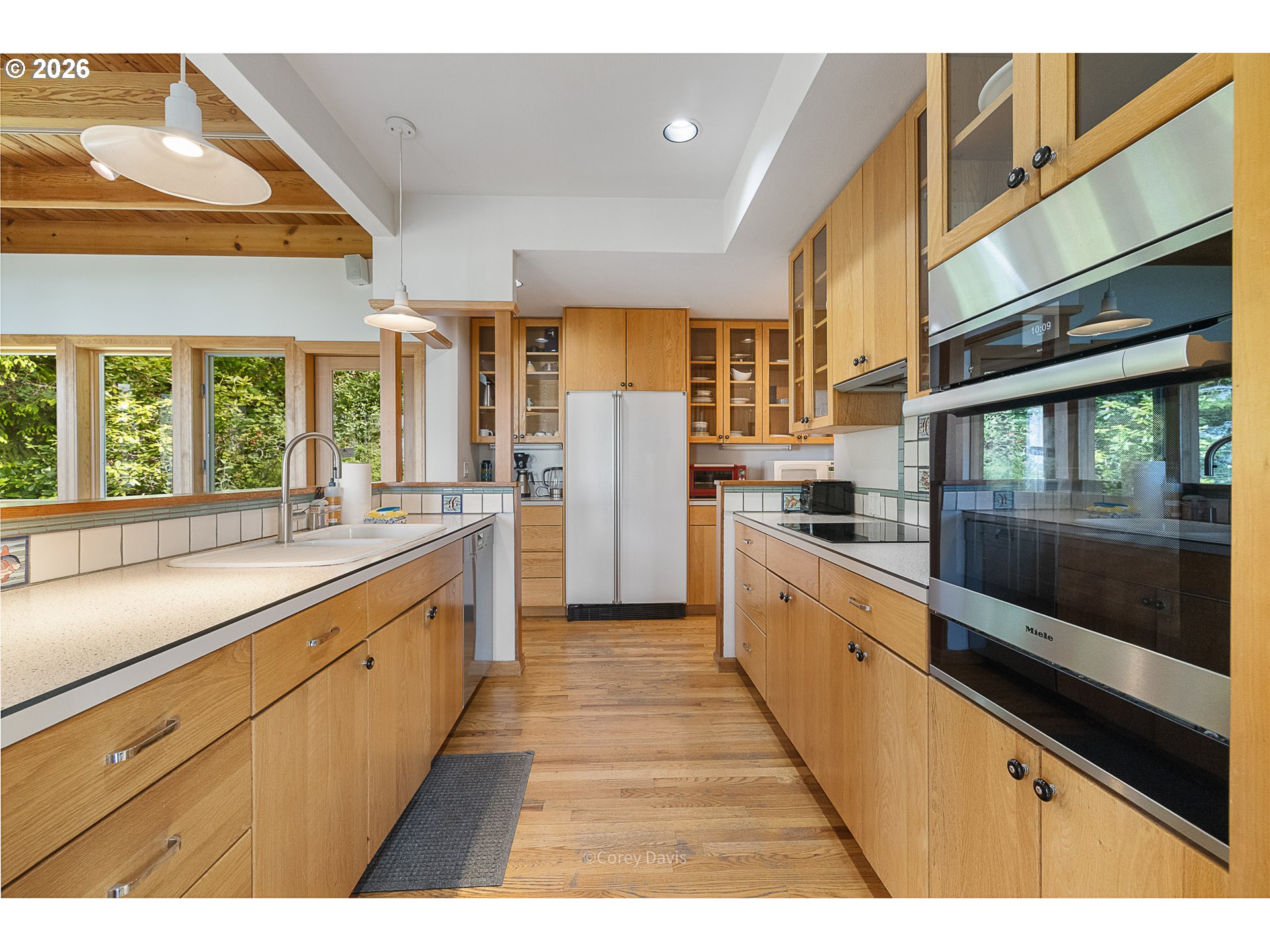 38295 Beulah Reed Road Nehalem, OR 97131 - Photo 20 of 42 a large kitchen with stainless steel appliances kitchen island a large counter tops and a large window