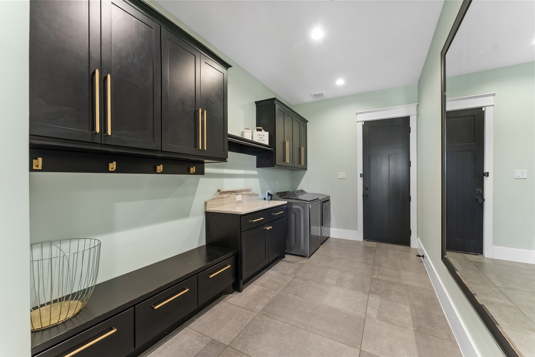 14019 Beartooth Bend Trail Conroe, TX 77384 - Photo 23 of 28 Spacious utility room with custom cabinetry, built-in storage, and convenient folding station.