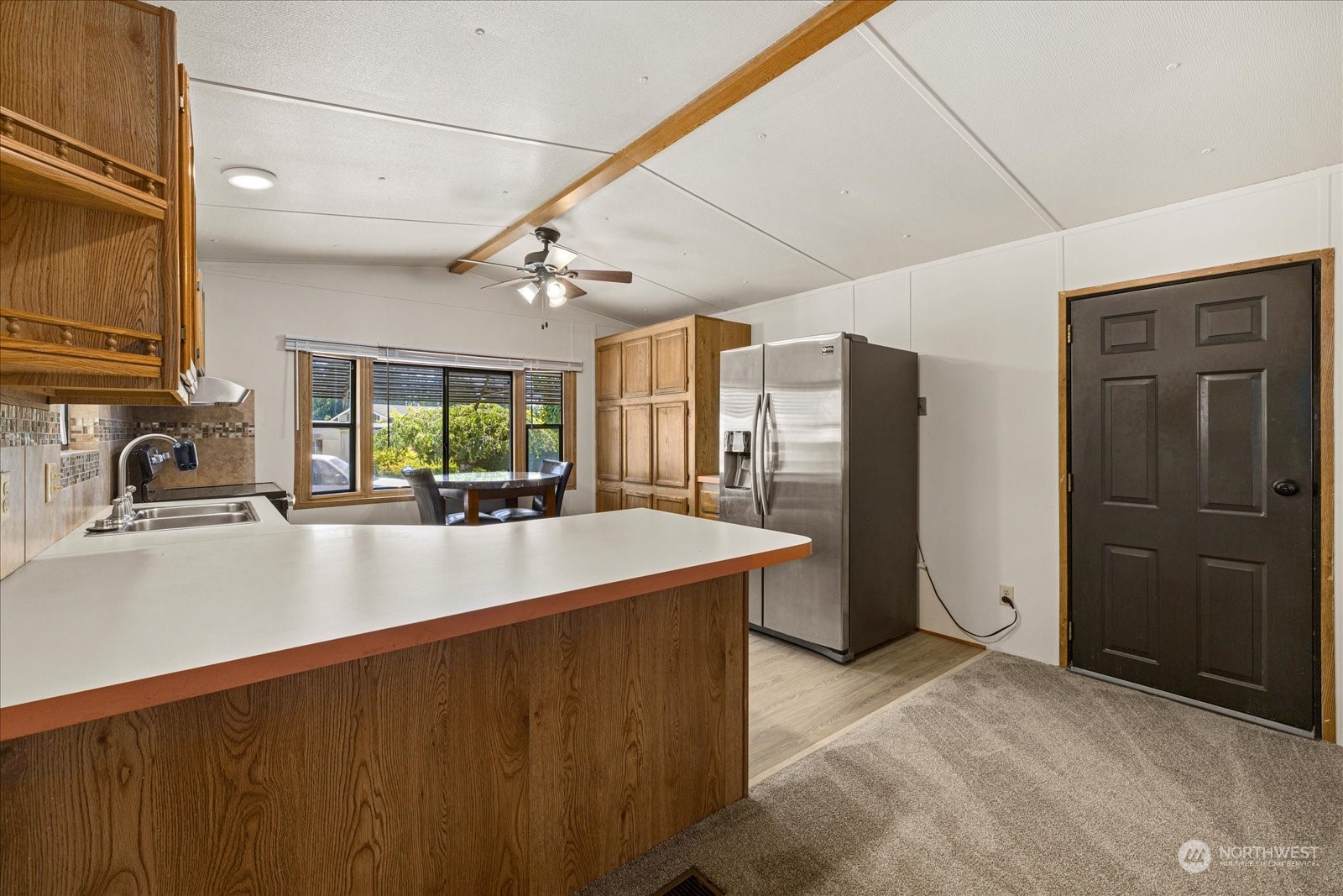 2302 R Street Southeast, Unit 46 Auburn, WA 98002 - Photo 13 of 25 a kitchen with stainless steel appliances a sink stove and refrigerator