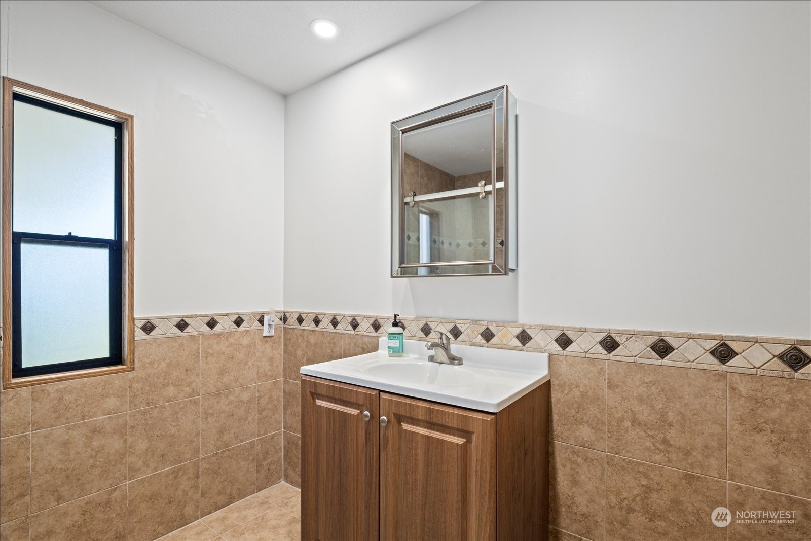 2302 R Street Southeast, Unit 46 Auburn, WA 98002 - Photo 17 of 25 a bathroom with a sink and a mirror