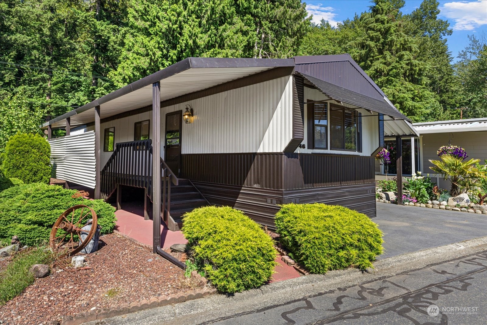 2302 R Street Southeast, Unit 46 Auburn, WA 98002 - Photo 2 of 25 a front view of house with a garden