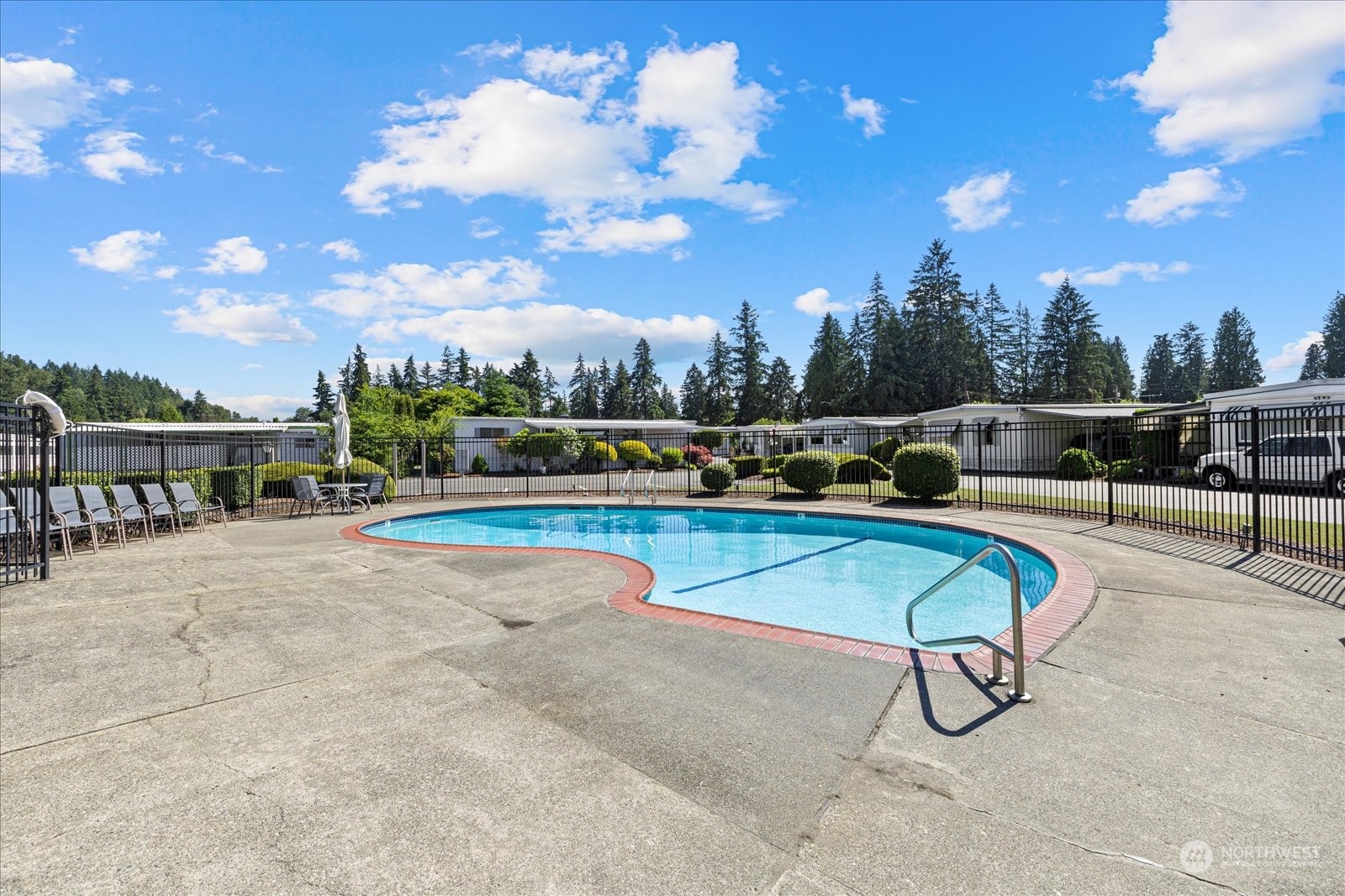 2302 R Street Southeast, Unit 46 Auburn, WA 98002 - Photo 24 of 25 a swimming pool with outdoor seating and yard in back