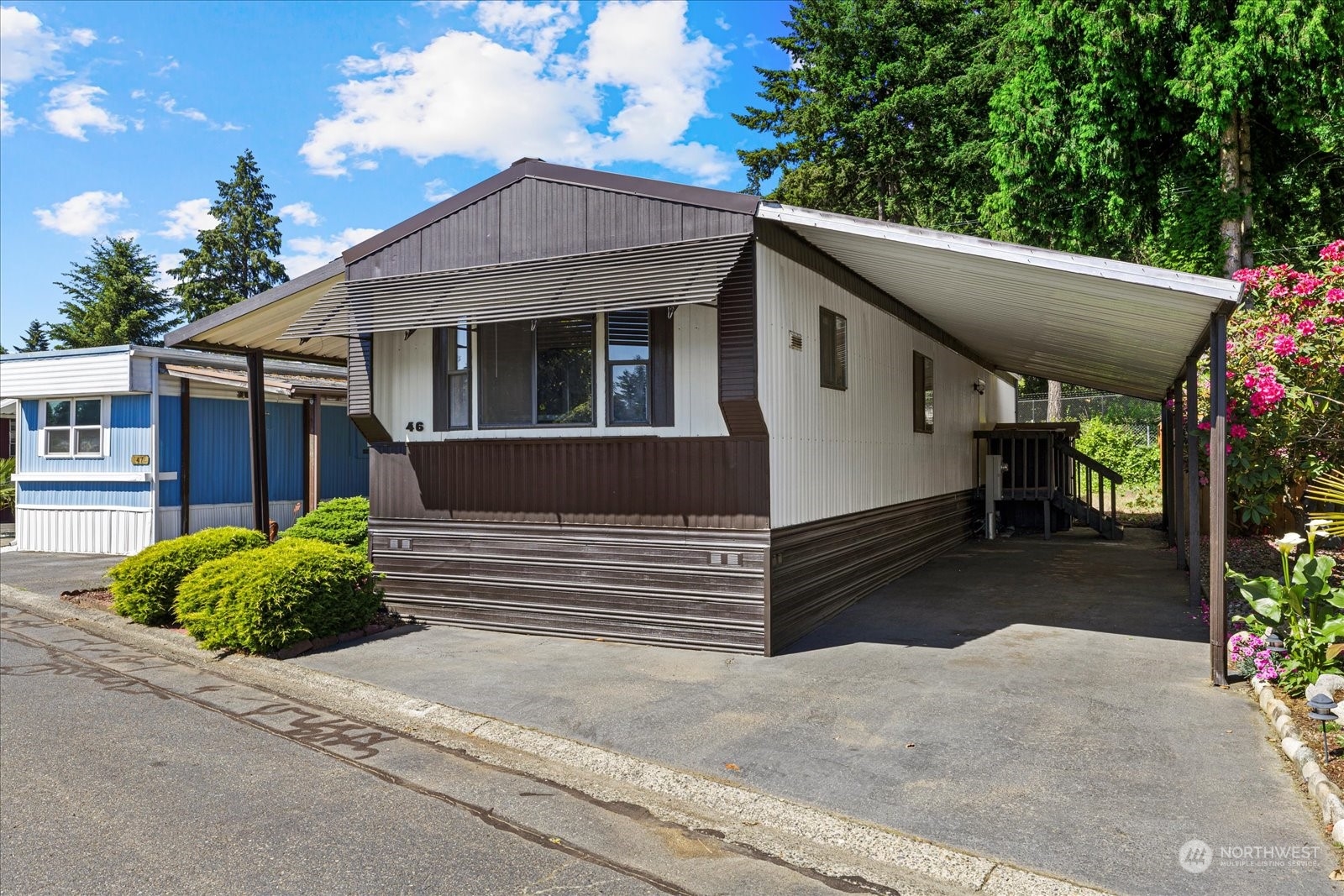 2302 R Street Southeast, Unit 46 Auburn, WA 98002 - Photo 3 of 25 a front view of a house with a yard