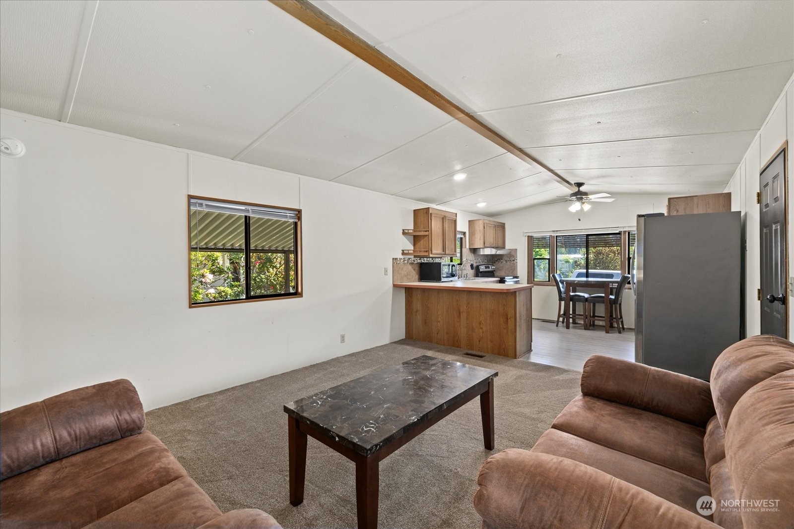 2302 R Street Southeast, Unit 46 Auburn, WA 98002 - Photo 8 of 25 a living room with furniture and kitchen view