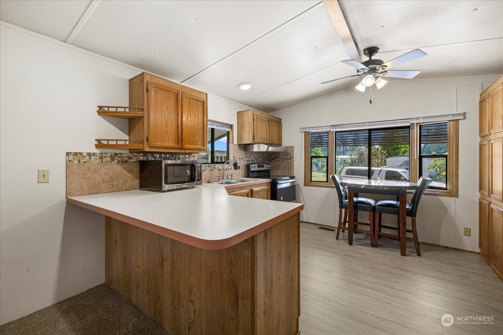 2302 R Street Southeast, Unit 46 Auburn, WA 98002 - Photo 9 of 25 a kitchen with a sink a counter top space appliances and cabinets
