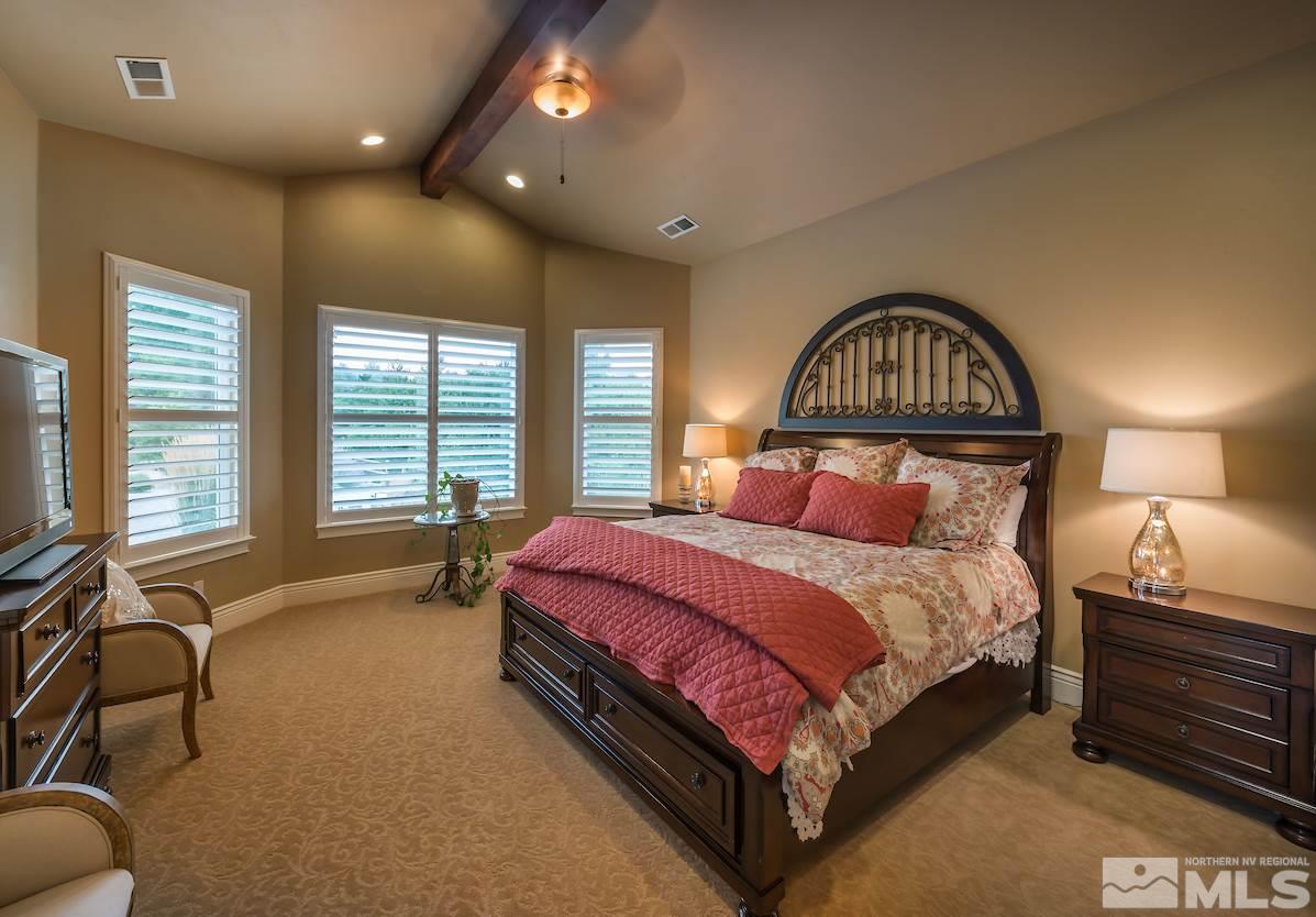 12745 Silver Wolf Road Reno, NV 89511 - Photo 13 of 21 a spacious bedroom with a bed and a flat screen tv
