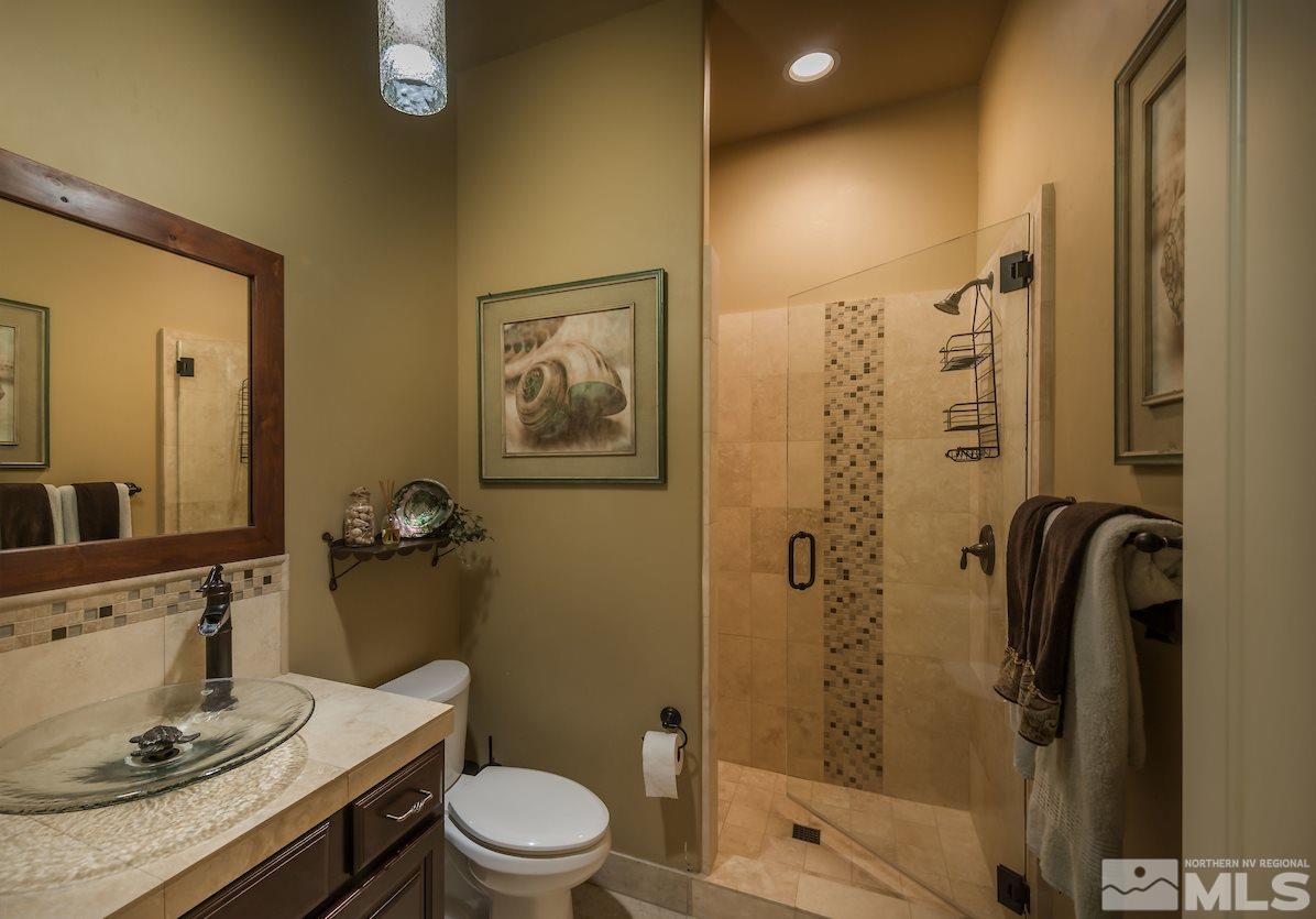 12745 Silver Wolf Road Reno, NV 89511 - Photo 16 of 21 a bathroom with a sink a toilet and shower