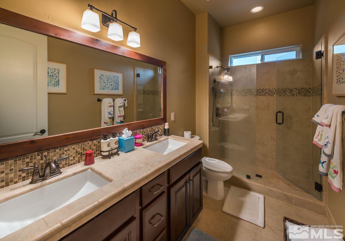12745 Silver Wolf Road Reno, NV 89511 - Photo 19 of 21 a bathroom with a sink and a mirror